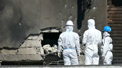 Forensic investigators examine the location of impact after a Russian drone struck an apartment building in Galati, eastern Romania