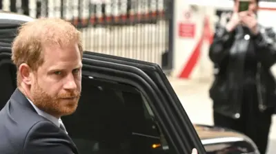 Prince Harry getting out of a taxi