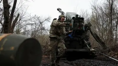 A Ukrainian gunner prepares to fire a Bohdana self-propelled howitzer towards Russian troops