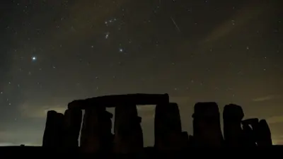 A meteor streaks in the skies above Stonehenge