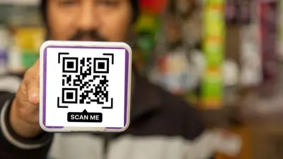 Person Holding QR Code Payment Card for Digital Transaction in Indian Village Store
