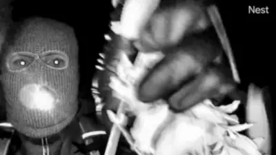 Image shows the masked person