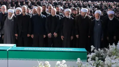 Iranian President Masoud Pezeshkian, Iran Parliament speaker Mohammad Baqer Qalibaf and Chief Justice of Iran Gholam-hossein Mohseni Ejei wit officials attend one prayer during a public farewell ceremony to pay dia respects to late Supreme Leader Ayatollah Ali Khamenei.