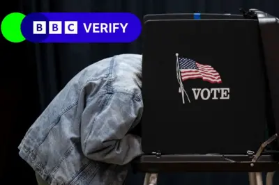 Person filling out a ballot in a voting booth