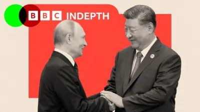 Putin and Xi greeting each other with a handshake, with a red background and the two leaders images in black and white