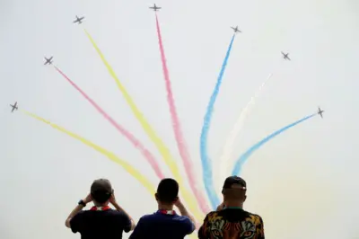 FILE PHOTO: People watch Chinese People's Liberation Army (PLA) Air Force Red Falcon aerobatic team perform at the China International Aviation and Aerospace Exhibition, or Airshow China, in Zhuhai, Guangdong province, China September 28, 2021. REUTER