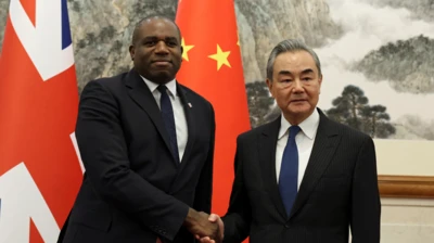 Foreign Secretary David Lammy and Chinese Foreign Minister Wang Yi shake hands