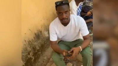 Foto of AbdulSamad Jamiu wia e wear im NYSC uniform.