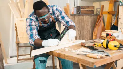 Foto of male carpenter wey dey work for im workshop