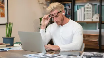 Man looks at laptop