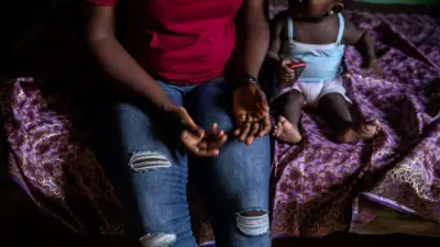 A woman and her child rest on June 26, 2019 in Benin City, at one of the shelters of the Society For the Empowerment Of Young Persons (SEYP).