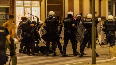 протест у ваљеву, полицајац туче момка који лежи на улици у Ваљеву, полицајци бију момка који лежи склупчан на улици

