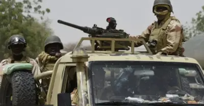 Military personnel wey dey inside armoured vehicle fully armed