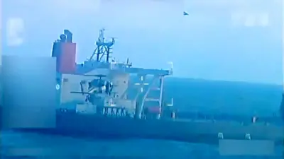 The tanker is seen with a bird flying above it with a military style crosshair overlain in a grab from video