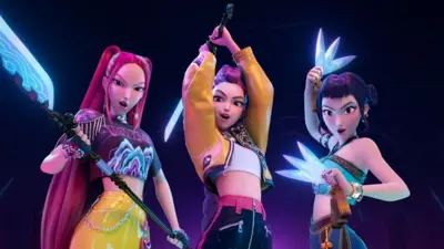 Three young women from the movie Kpop Demon Hunters posing with their weapons looking at the camera