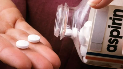 Aspirin kutusundan ele düşen iki adet hap