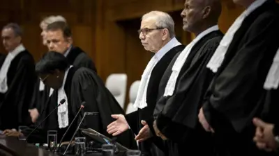 International Court of Justice (ICJ) President Nawaf Salam (C) stands during a ruling over the situation in Rafah, southern Gaza, in the Hague, Netherlands