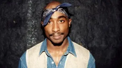 Rapper Tupac Shakur poses for photos backstage after his performance at the Regal Theater in Chicago in March 1994.