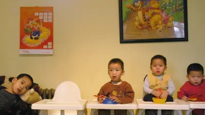 Orphans prepare to eat dinner at Shunyi Children's Home on January 28, 2005 in Beijing, China