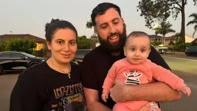 Merna Taleski outside the church with her husband and daughter
