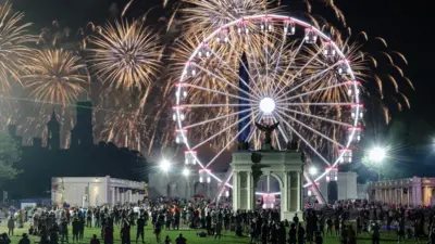 People watch a fireworks display that is attempting the largest firework display in history with 850,000 fireworks