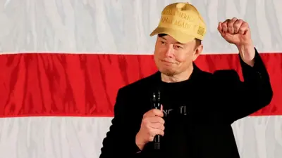 Tesla CEO and X owner Elon Musk, wey dey support Republican presidential nominee former U.S. President Donald Trump, wave as e speak about voting during one America PAC Town Hall for Folsom, Pennsylvania, U.S., October 17, 2024.