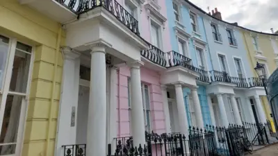 A street scene showing multi-coloured townhouses that featured in the Paddington film.