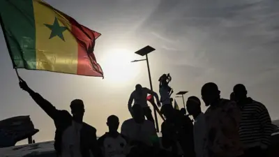 Young pipo hold Senegal flag during match