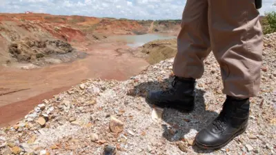 The feet of a person looking out over Ruashi mine