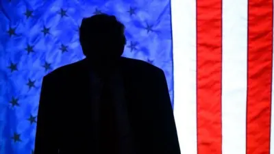 A silhouette of Donald Trump against the American flag