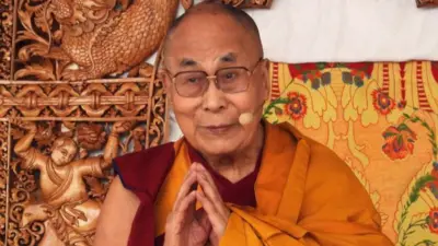 Tibetan spiritual leader the Dalai Lama holds his hands together in a prayer gesture as he leads a teachings gathering in Leh on 28 July 2022