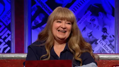 Janey Godley, who has long wavy brown hair and a navy blue blouse, on the panel of Have I Got News For You