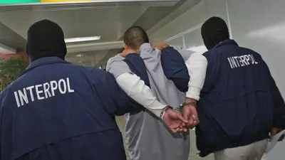 Interpol hold criminal wit handcuff