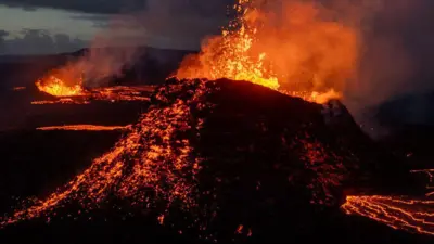 Lava spews from multiple craters of the Sundhnkur volcano on June 3, 2024 on the Reykjanes peninsula near Grindavik, Iceland. 