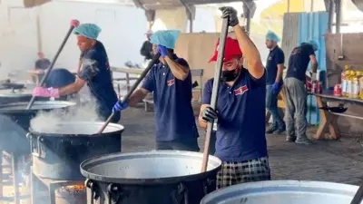 Cooks stir pots of rice and lentils at a community food kitchen run by the US-based humanitarian organisation Anera in Khan Younis, southern Gaza