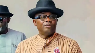 Peter Akpe wear cream stripe shirt with black bowler hat