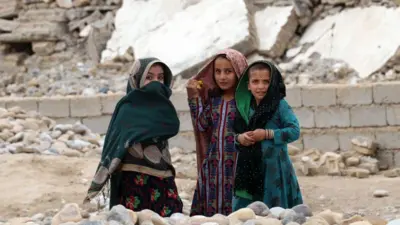 Three young girls in Sangin market