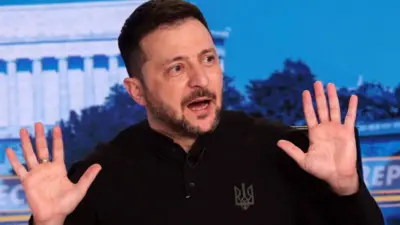  Volodymyr Zelensky speaking, with palms facing the camera