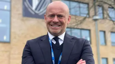 A man with arms folded standing in front of Caldicot School