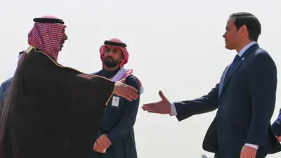 US Secretary of State Marco Rubio shakes hands with Saudi Arabia's Deputy Minister for Protocol Affairs Abdulmajeed Al-Smari at King Khalid International Airport, in Riyadh