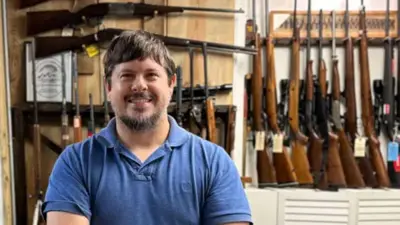 James Rabun in his family's gun store, surrounded by different kinds of guns