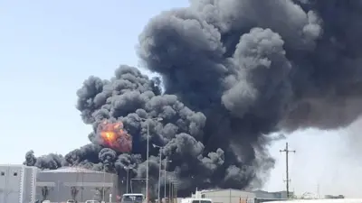 Smoke and fire billows over a fuel depot in Port Sudan.