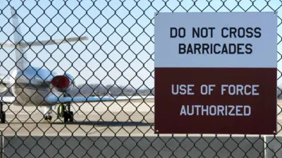 Perimeter sign at Dover Air Force Base that reads 'do not cross barricades, use of force authorized'