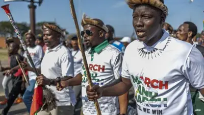 
Protesters from "March and March" Movement chant slogans during demonstration for Umlazi township south-west of Durban, on June 22, 2026. 