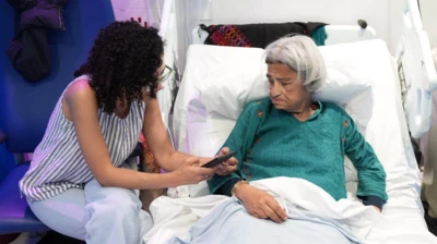 Sanaa Seif (L) sits beside her mother Laila Soueif (R) at St Thomas' hospital, London