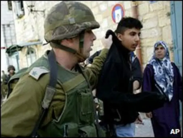 Soldado israelí con ciudadano palestino