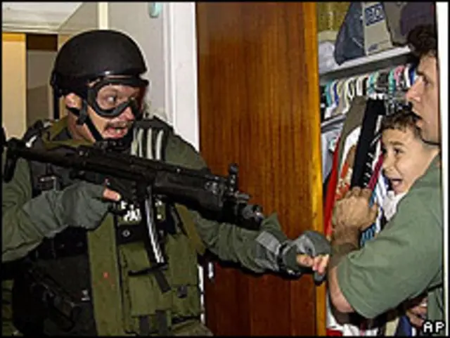 Elián González con un familiar en el momento en que la policía entra en la casa de Miami en la que residió varios meses