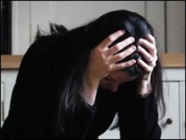 सिर पर हाथ पर रखी महिला