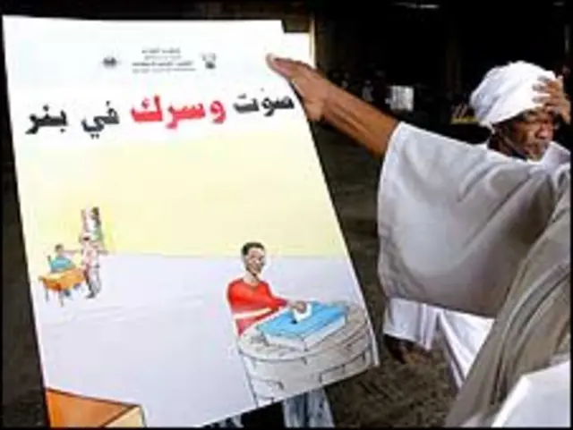 مسؤول يطالع ملصقا دعائيا