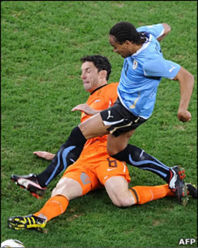 Mark van Bommel lucha contra el uruguayo Pereira